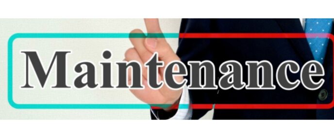 スーツ姿の人物が指を立てる背景に「Maintenance」と書かれた文字。